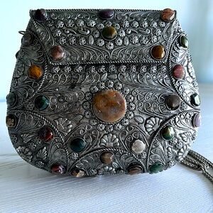 Antique metal jeweled crossbody but can be use as a clutch as well.